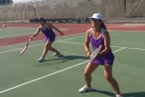 Lemoore's Holly Cassina (left) and Aliana Cabuhat warm up before a recent match. The Tigers host Hanford in a West Yosemite League showdown Wednesday, Sept. 13.